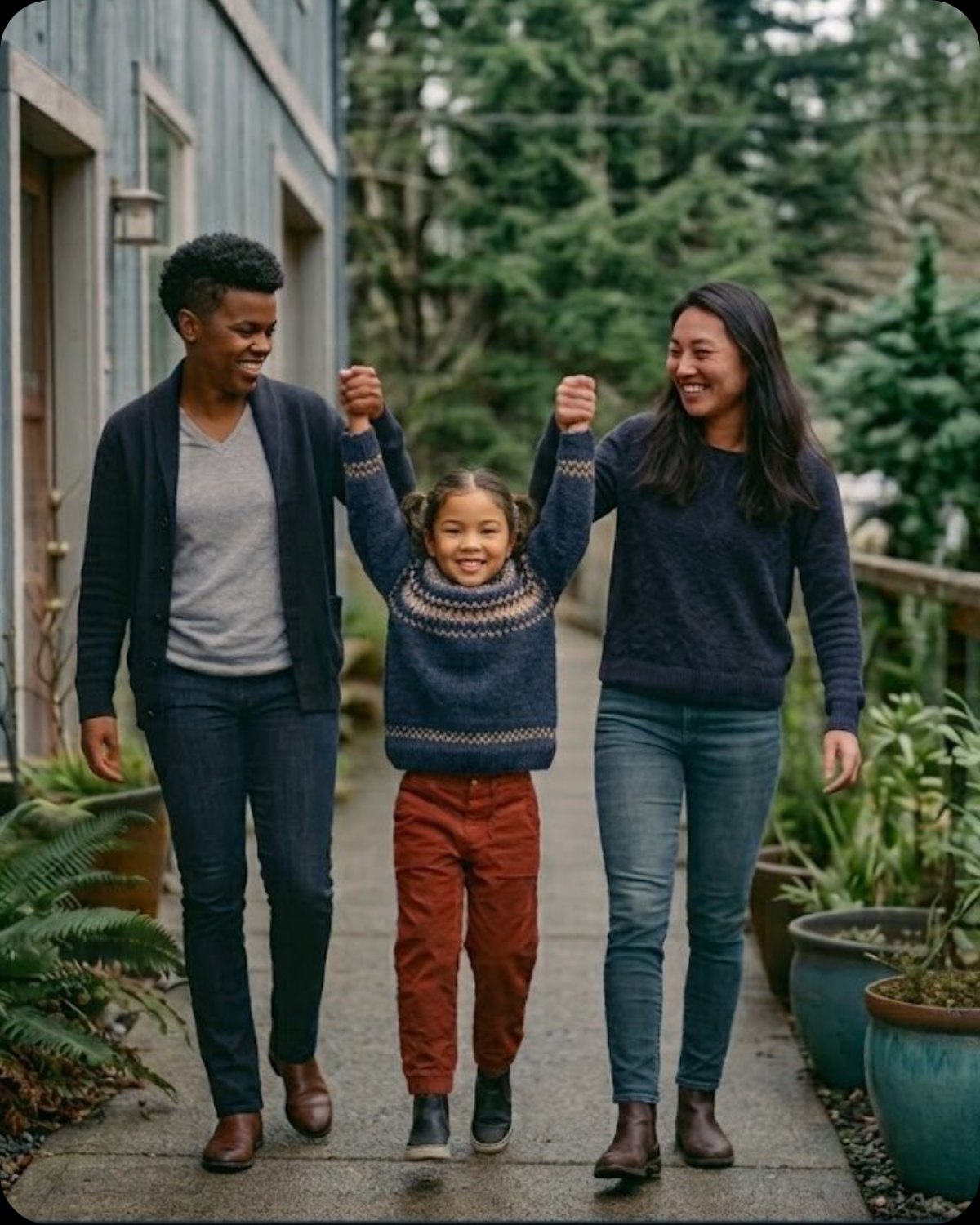 Two mothers swinging their daughter between them on a garden path